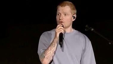 Singer Ed Sheeran speaks on stage as he addresses a controversy over Macklemore being pulled from the tour after saying 'Free Palestine' at a show early this month, in Philadelphia