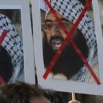Activists carry placards of the chief of Jaish-e-Mohammad, Maulana Masood Azhar during a protest against the attack on the air force base in Pathankot.