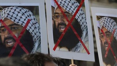 Activists carry placards of the chief of Jaish-e-Mohammad, Maulana Masood Azhar during a protest against the attack on the air force base in Pathankot.