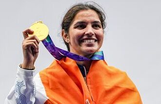 India's Neeru Dhanda poses with the national flag during the victory ceremony for the women's trap shooting individual event at Asian Games 2026.
