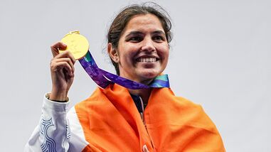 India's Neeru Dhanda poses with the national flag during the victory ceremony for the women's trap shooting individual event at Asian Games 2026.