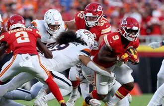 Kenneth Walker III #9 of the Kansas City Chiefs runs the ball against the Denver Broncos during the first quarter in the game at Arrowhead Stadium.
