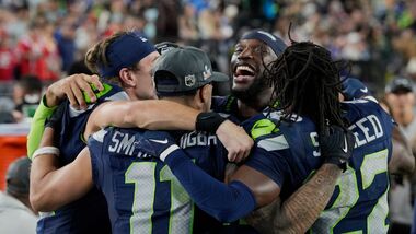 Seattle Seahawks players celebrate on the sideline late in the game against the New England Patriots during the NFL Super Bowl 60 football game. 9file photo)