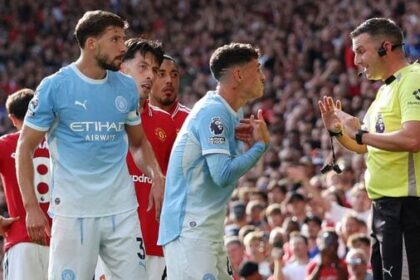 Manchester City's Phil Foden remonstrates with referee Michael Oliver after being shown a red card against Manchester United.