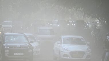 Commuters make their way through a haze-covered and dusty stretch of road as air pollution levels rise in New Delhi (Photo by Sanchit Khanna/ Hindustan Times)