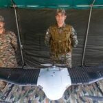 Drass: Army personnel stand near an Unmanned Aerial Vehicle (UAV) on display on the Kargil Vijay Diwas, at Matayen in Drass, Ladakh, Sunday, July 26, 2026. (PTI Photo/S Irfan)(PTI07_26_2026_000289B)