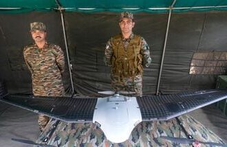Drass: Army personnel stand near an Unmanned Aerial Vehicle (UAV) on display on the Kargil Vijay Diwas, at Matayen in Drass, Ladakh, Sunday, July 26, 2026. (PTI Photo/S Irfan)(PTI07_26_2026_000289B)