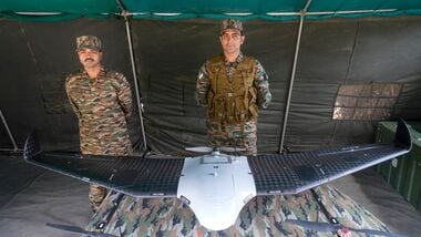 Drass: Army personnel stand near an Unmanned Aerial Vehicle (UAV) on display on the Kargil Vijay Diwas, at Matayen in Drass, Ladakh, Sunday, July 26, 2026. (PTI Photo/S Irfan)(PTI07_26_2026_000289B)