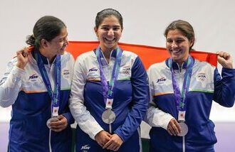 India's Manisha Keer (Left), Ashima Ahlawat (Centre) and Neeru Dhanda (Right) pose with the national flag after winning the silver medal during the victory ceremony for the women's trap shooting team event at the 20th Asian Games 2026 in Nagoya.