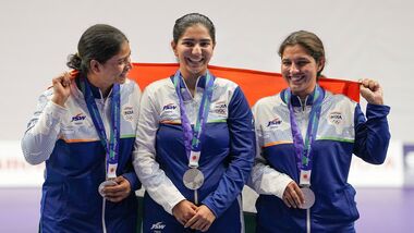 India's Manisha Keer (Left), Ashima Ahlawat (Centre) and Neeru Dhanda (Right) pose with the national flag after winning the silver medal during the victory ceremony for the women's trap shooting team event at the 20th Asian Games 2026 in Nagoya.