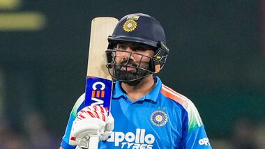 India's Rohit Sharma celebrates his half century during the second One Day International (ODI) cricket match between India and West Indies, in Guwahati, Assam.
