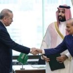 This handout photograph taken and released by the Turkish Presidency press office on August 7, 2026, shows Turkey's President Recep Tayyip Erdogan (L) shaking hands with Pakistans Prime Minister Shehbaz Sharif as Saudi Arabia's Crown Prince Mohammed bin Salman (2nd R) looks on after signing a joint defence agreement in Mecca. (Photo by Handout / Turkish Presidency Press Office / AFP)