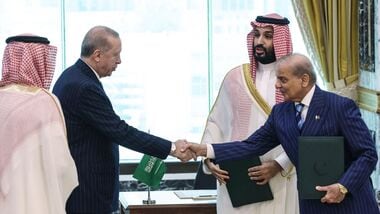 This handout photograph taken and released by the Turkish Presidency press office on August 7, 2026, shows Turkey's President Recep Tayyip Erdogan (L) shaking hands with Pakistans Prime Minister Shehbaz Sharif as Saudi Arabia's Crown Prince Mohammed bin Salman (2nd R) looks on after signing a joint defence agreement in Mecca. (Photo by Handout / Turkish Presidency Press Office / AFP)