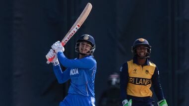 India's Smriti Mandhana plays a shot in front of Sri Lanka's Kaushini Nuthyangana in the women's gold medal match at Asian Games 2026.