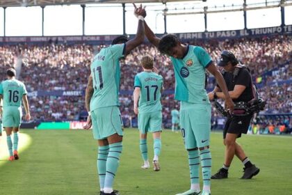 FC Barcelona's Lamine Yamal celebrates scoring their second goal with Raphinha