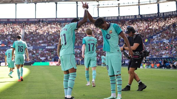 FC Barcelona's Lamine Yamal celebrates scoring their second goal with Raphinha