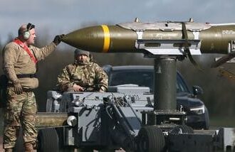US-Israel-Iran War: US Military personnel take away Joint Direct Attack Munitions (JDAMs), removed from a US Air Force B-1 Lancer bomber at RAF Fairford in south-west England on 15 March 2026. Fairford is one of two bases, along with the Diego Garcia facility in the Indian Ocean, that the UK has given the US permission to use for 'specific defensive operations into Iran' to destroy Iranian missiles at source, the British defence minister said in a statement. (Photo by Henry NICHOLLS / AFP) (file photo)