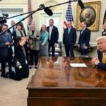 A file image of President Donald Trump speaking with reporters in the Oval Office of the White House in Washington.