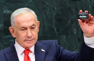 Israeli Prime Minister Benjamin Netanyahu holds up a pager as he addresses the 81st United Nations General Assembly (UNGA) at UN headquarters in New York City, US, September 24, 2026.   REUTERS/Mike Segar