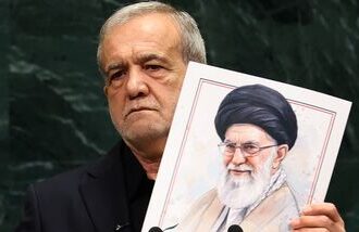 Iran's President Masoud Pezeshkian speaks as he holds a picture of Ali Khamenei, former Supreme Leader of Iran, during the 81st United Nations General Assembly at the United Nations Headquarters in New York, on September 23, 2026. (Photo by TIMOTHY A. CLARY / AFP)