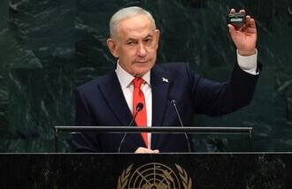 Israel's Prime Minister Benjamin Netanyahu holds up a pager as he speaks during the 81st United Nations General Assembly at the United Nations Headquarters in New York, on September 24, 2026. (Photo by TIMOTHY A. CLARY / AFP)