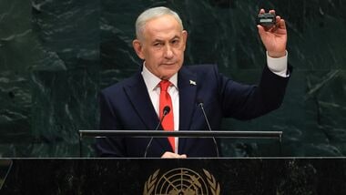 Israel's Prime Minister Benjamin Netanyahu holds up a pager as he speaks during the 81st United Nations General Assembly at the United Nations Headquarters in New York, on September 24, 2026. (Photo by TIMOTHY A. CLARY / AFP)