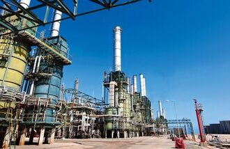 Refining towers are seen at the Zawiya oil refinery near Tripoli, Libya, in this file photo. Crude exports from Libya are likely to remain limited regardless of how quickly the country's civil conflict ends, limiting declines in Brent oil prices. (Photographer: Shawn Baldwin/Bloomberg)