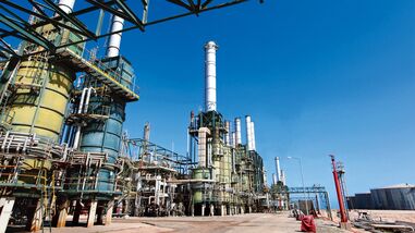 Refining towers are seen at the Zawiya oil refinery near Tripoli, Libya, in this file photo. Crude exports from Libya are likely to remain limited regardless of how quickly the country's civil conflict ends, limiting declines in Brent oil prices. (Photographer: Shawn Baldwin/Bloomberg)