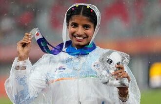 Ancy Sojan poses for a photograph with women's long jump silver medal at the Asian Games 2026.