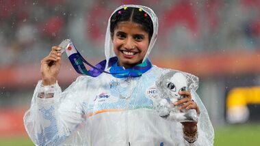 Ancy Sojan poses for a photograph with women's long jump silver medal at the Asian Games 2026.