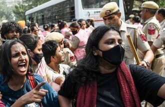 Protesters try to avoid detention by the Delhi police near Connaught Place amid the CJP protest in New Delhi