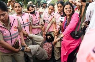 New Delhi, Oct 10 (ANI): Pink Force of the Delhi Police detains a protester near Connaught Place amid the CJP protest, in New Delhi on Saturday. (ANI Photo/Sumit)