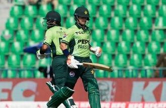 Pakistan's Maaz Sadaqat, right, and Babar Azam run between the wickets during the tri-series one-day international cricket match between Pakistan and Sril Lanka, in Lahore, Pakistan.