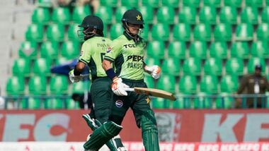Pakistan's Maaz Sadaqat, right, and Babar Azam run between the wickets during the tri-series one-day international cricket match between Pakistan and Sril Lanka, in Lahore, Pakistan.