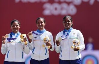 Asian Games 2026 Live Updates, Day 14: Gold medallist India's Kumkum Anil Mohod, Ankita Bhakat and Kirti celebrate on the podium during the victory ceremony.