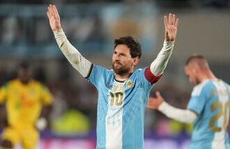 Argentina's Lionel Messi celebrates after scoring his team's third goal from the penalty spot during his final match for the national team against Benin in Buenos Aires.