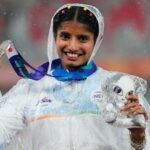 Women's long jump silver medalist India's Ancy Sojan Edappilly poses on the podium at the Asian Games in Nagoya.