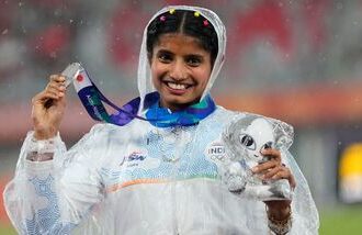 Women's long jump silver medalist India's Ancy Sojan Edappilly poses on the podium at the Asian Games in Nagoya.