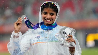 Women's long jump silver medalist India's Ancy Sojan Edappilly poses on the podium at the Asian Games in Nagoya.