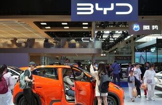 Visitors check a BYD Seagull electric vehicle (EV) displayed at the Beijing International Automotive Exhibition, or Auto China, in Beijing, China