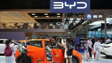Visitors check a BYD Seagull electric vehicle (EV) displayed at the Beijing International Automotive Exhibition, or Auto China, in Beijing, China