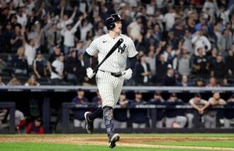 Ben Rice #22 of the New York Yankees celebrates as he round the bases after hitting a grand slam home run against the Boston Red Sox during the eighth inning in game one of the American League Wild Card Series at Yankee Stadium.