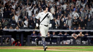 Ben Rice #22 of the New York Yankees celebrates as he round the bases after hitting a grand slam home run against the Boston Red Sox during the eighth inning in game one of the American League Wild Card Series at Yankee Stadium.