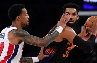 New York Knicks' Karl-Anthony Towns (Right) controls the ball against John Collins of Detroit Pistons during an NBA game in New York on Tuesday.