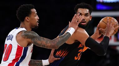 New York Knicks' Karl-Anthony Towns (Right) controls the ball against John Collins of Detroit Pistons during an NBA game in New York on Tuesday.