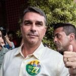 Flavio Bolsonaro, Brazilian presidential candidate, center, arrives at a polling station to accompany his wife voting during the general election in Rio de Janeiro, Brazil, on Sunday, Oct. 4, 2026.