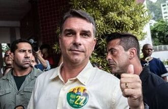 Flavio Bolsonaro, Brazilian presidential candidate, center, arrives at a polling station to accompany his wife voting during the general election in Rio de Janeiro, Brazil, on Sunday, Oct. 4, 2026.