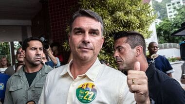 Flavio Bolsonaro, Brazilian presidential candidate, center, arrives at a polling station to accompany his wife voting during the general election in Rio de Janeiro, Brazil, on Sunday, Oct. 4, 2026.