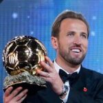 England's soccer player Harry Kane holds the player of the year trophy during the Ballon d'Or ceremony at the London Palladium Theatre.