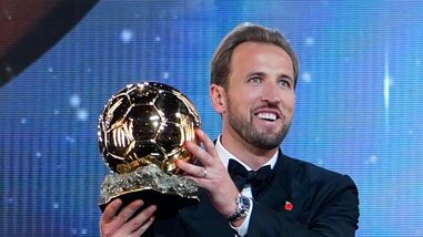 England's soccer player Harry Kane holds the player of the year trophy during the Ballon d'Or ceremony at the London Palladium Theatre.